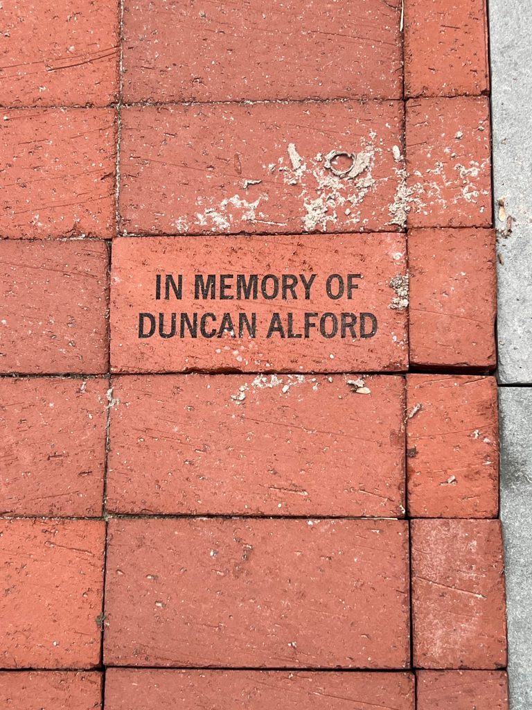 IN MEMORY OFDUNCAN ALFORD on a brick among bricks without writing